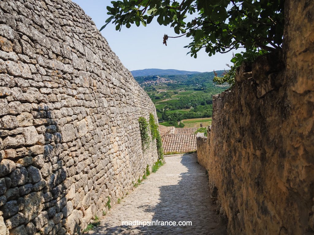high stone walls in a lane in Lacoste in the Luberon in Provence